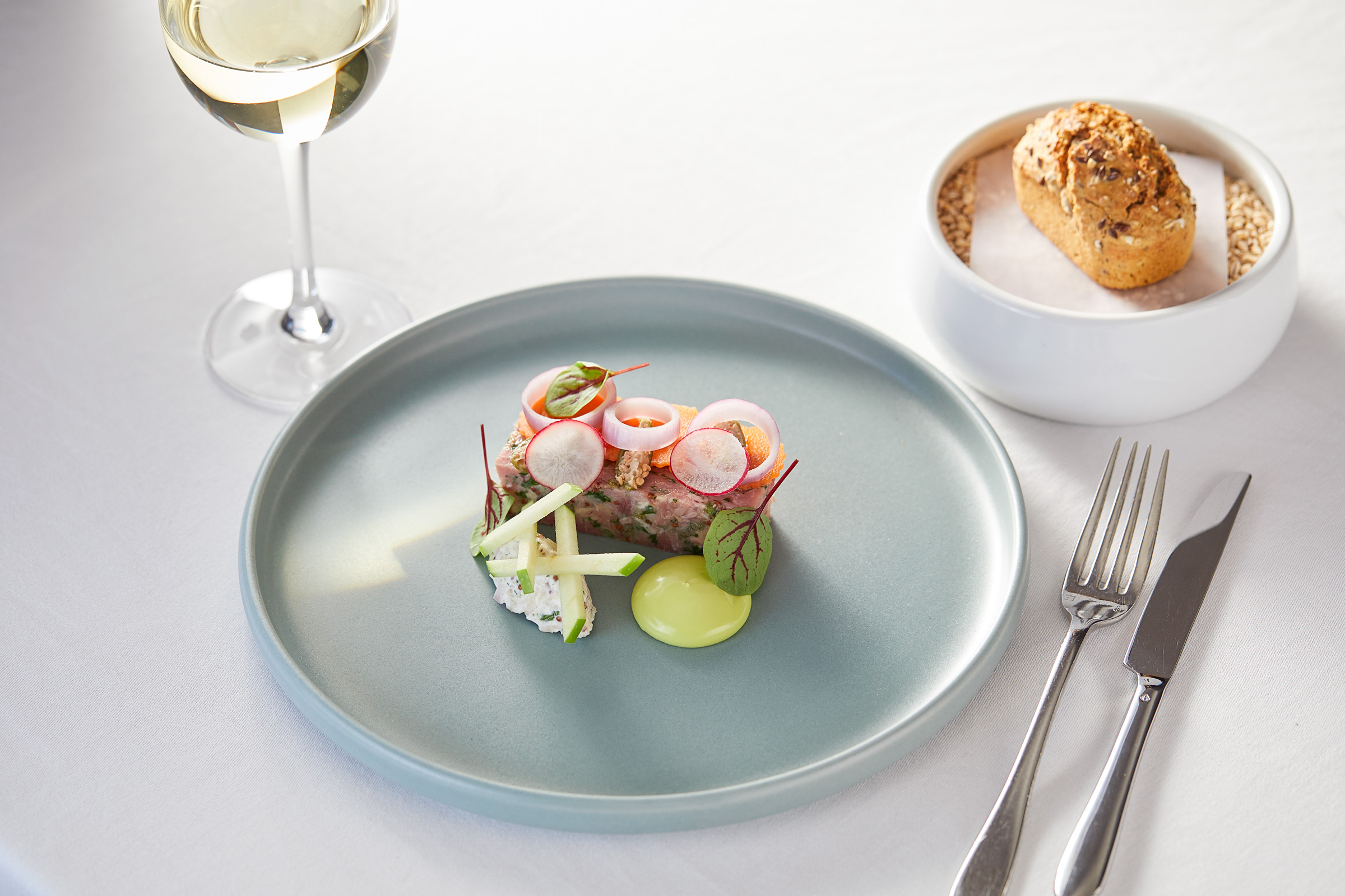 Tasting menu dish of Ham Hock Terrine and glass of white wine, Glasgow food and drink photographer Alastair Ferrier. Professional food and drink photography.